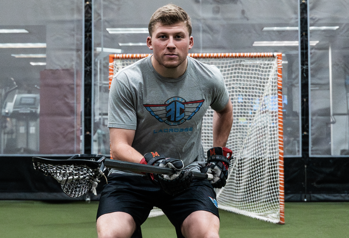 defender in lacrosse breaking down on the ball.